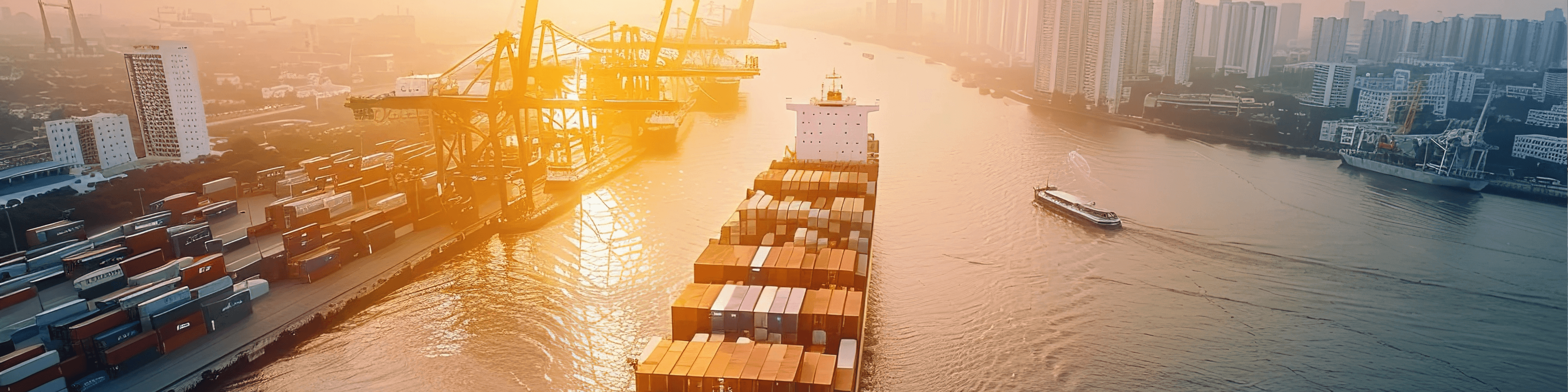 Shipping company container ship navigating through a port channel with cranes and city.