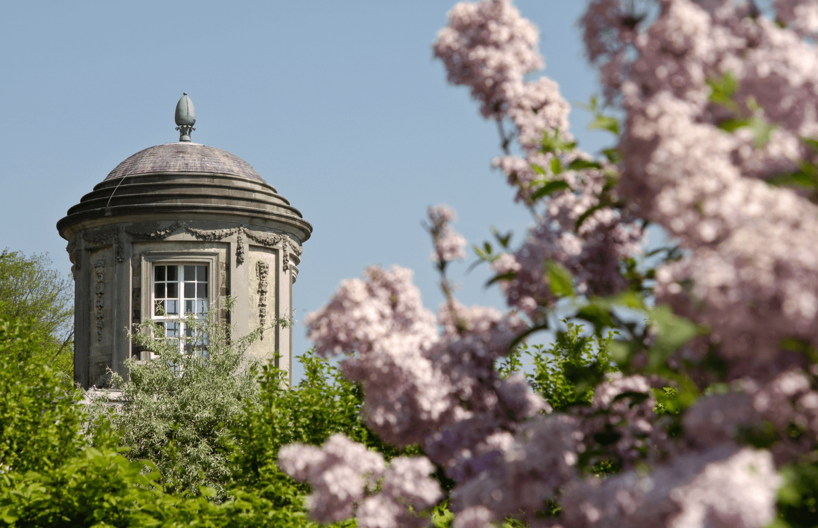 Blooming garden with historic pavilion as a symbol of the climate in Belgium