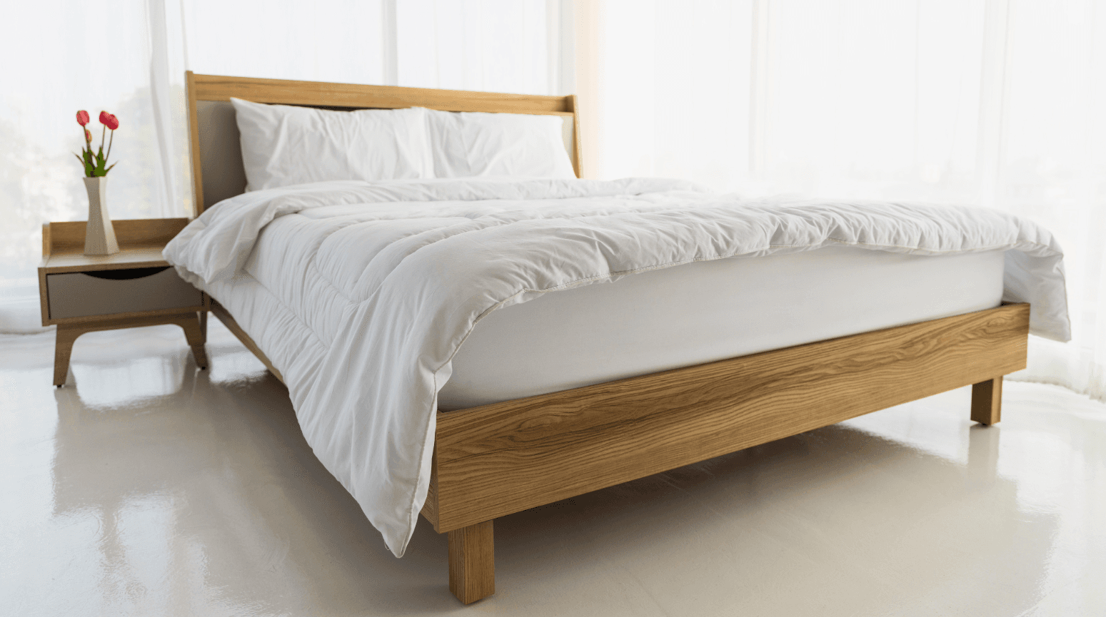 Modern bedroom with light wood frame – example of fully assembled bed