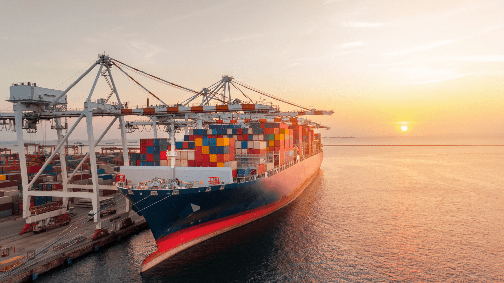 Container ship at sunset in port – symbolic image for planning to prevent maritime transport accidents