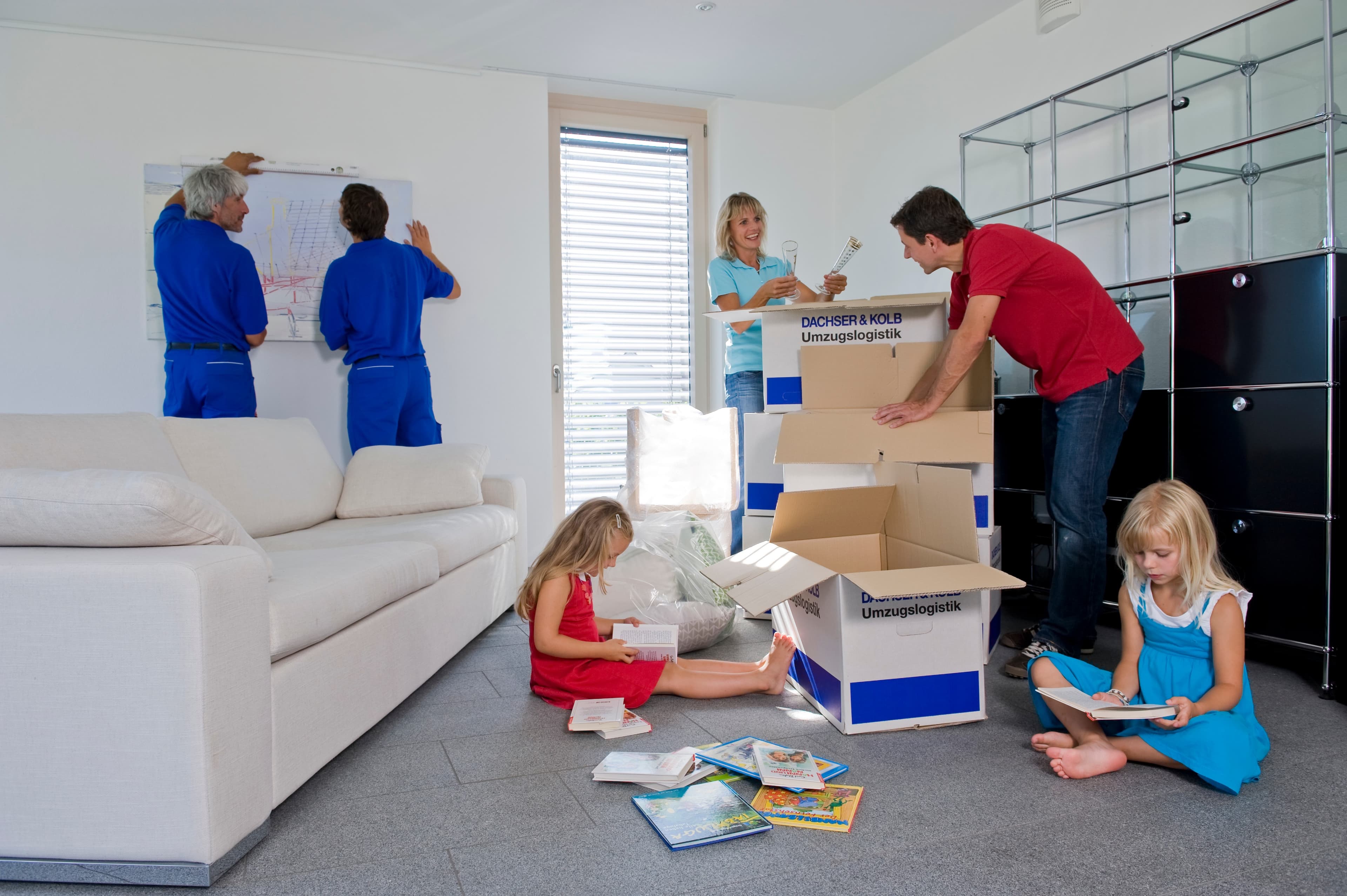 Full-service move in action: Furniture assembly, unpacking boxes, family settling into their new home.