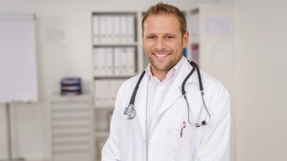 A doctor from Lithuania smiles at the camera
