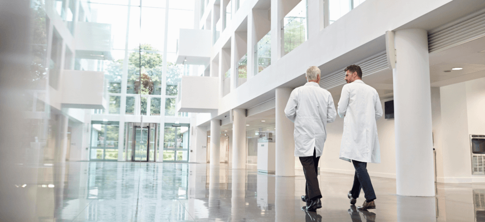 Two doctors are walking through the lobby of a hospital in Thailand