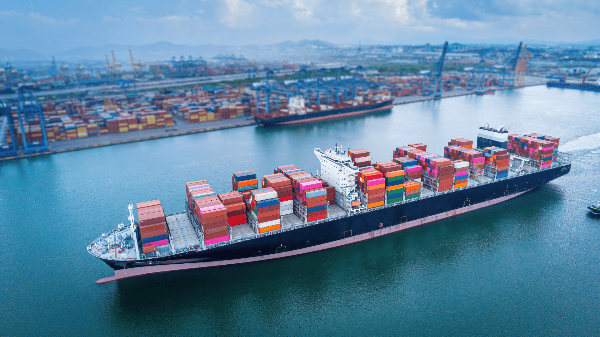 Container ship in a busy port, precise ETD coordination for global cargo shipping and supply chains.
