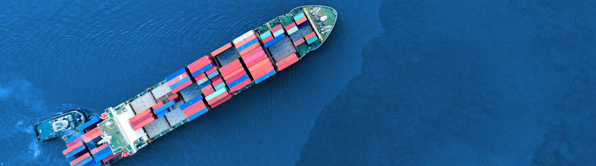 Container ship with tug from above – symbolic of navigation safety and maritime transport accidents