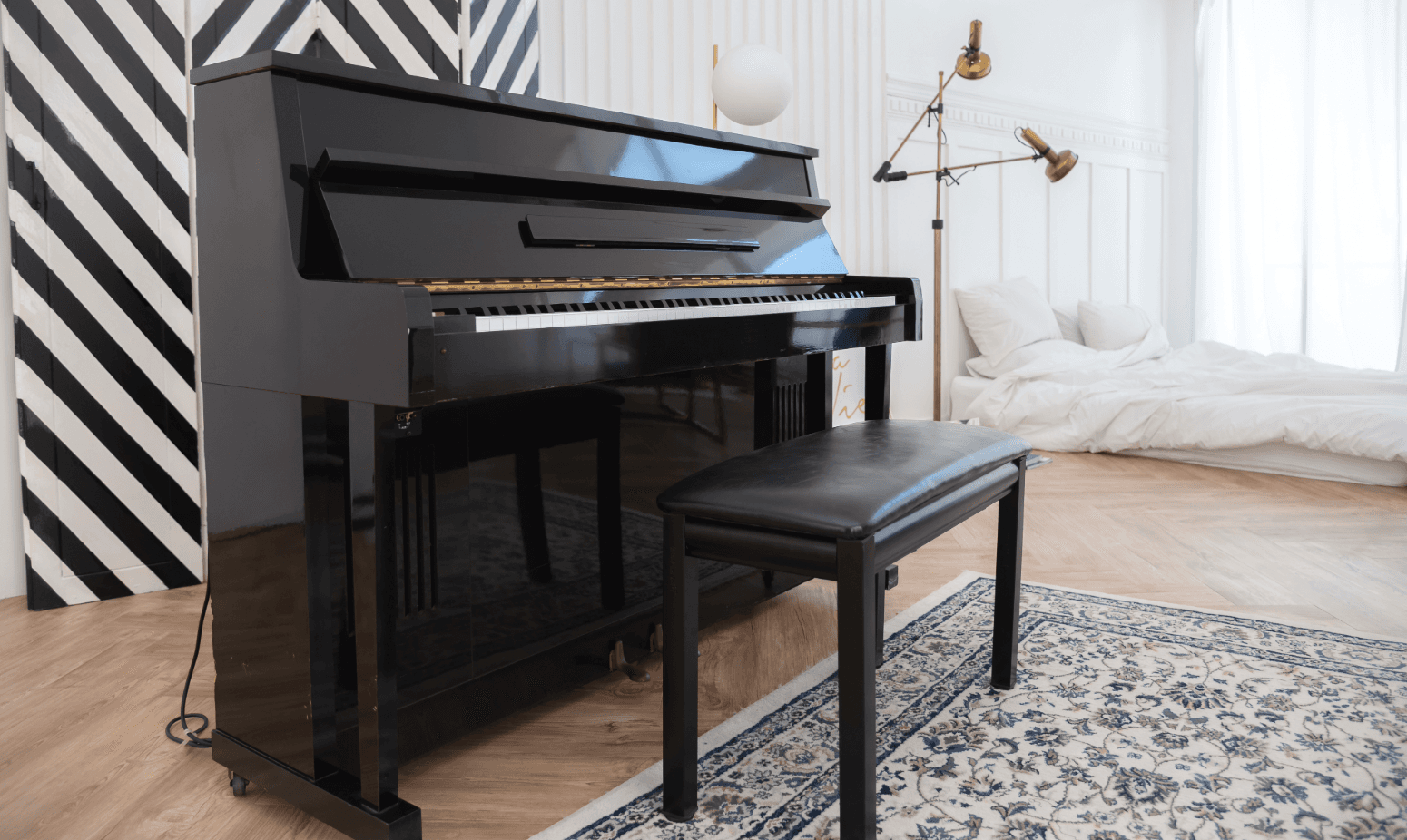 Black piano in modern bedroom – piano transport & grand relocation with care and expertise