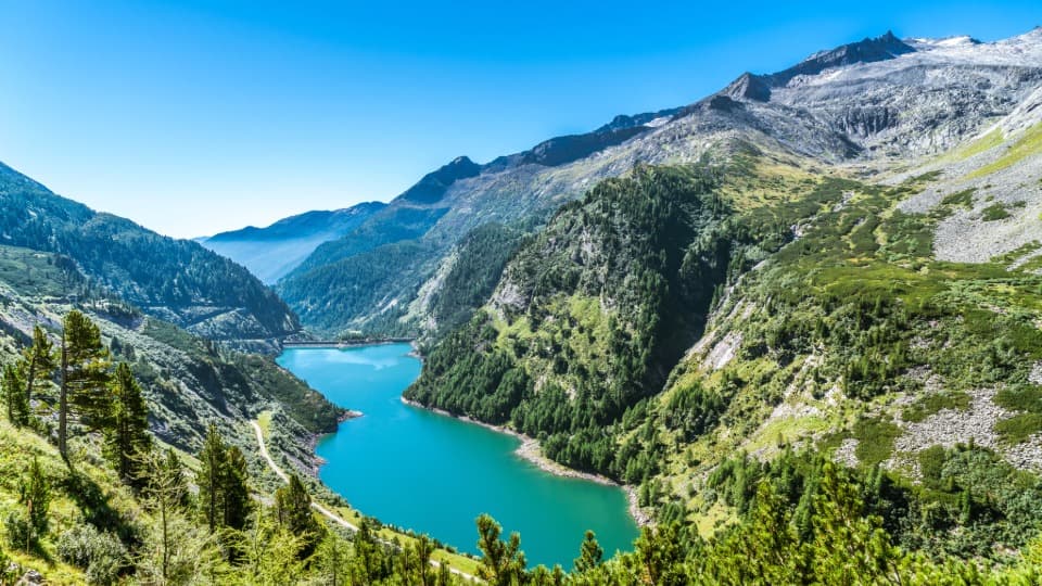 A landscape featuring mountains, forests, and a body of water in Malta