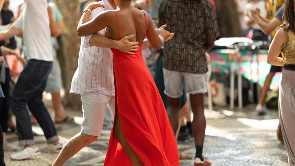 Several couples dance bachata at a celebration in the Dominican Republic.
