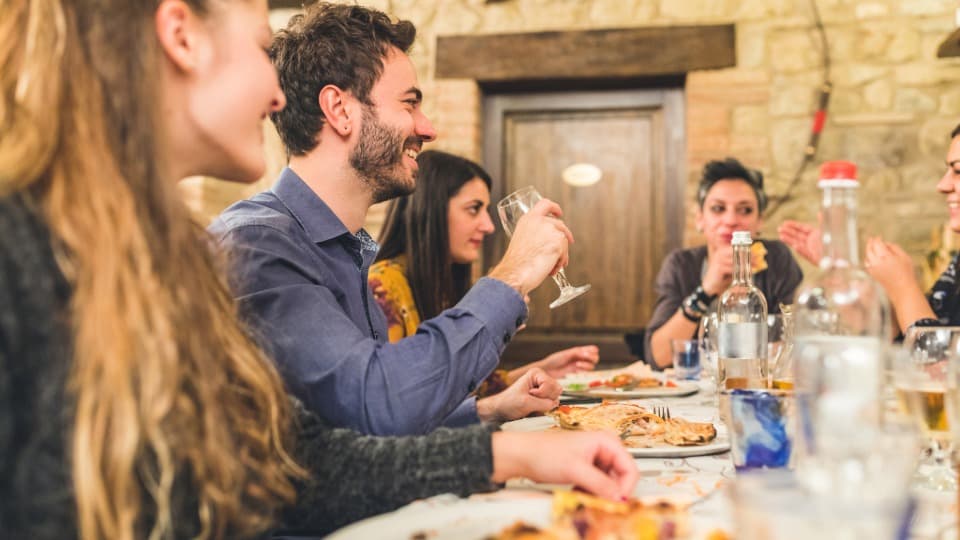 A social gathering in an Italian trattoria – integration and community through the Italian language.