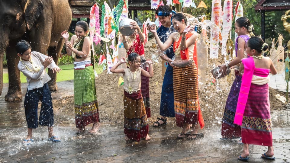 Children and teenagers splash each other with water during the Songkran Festival