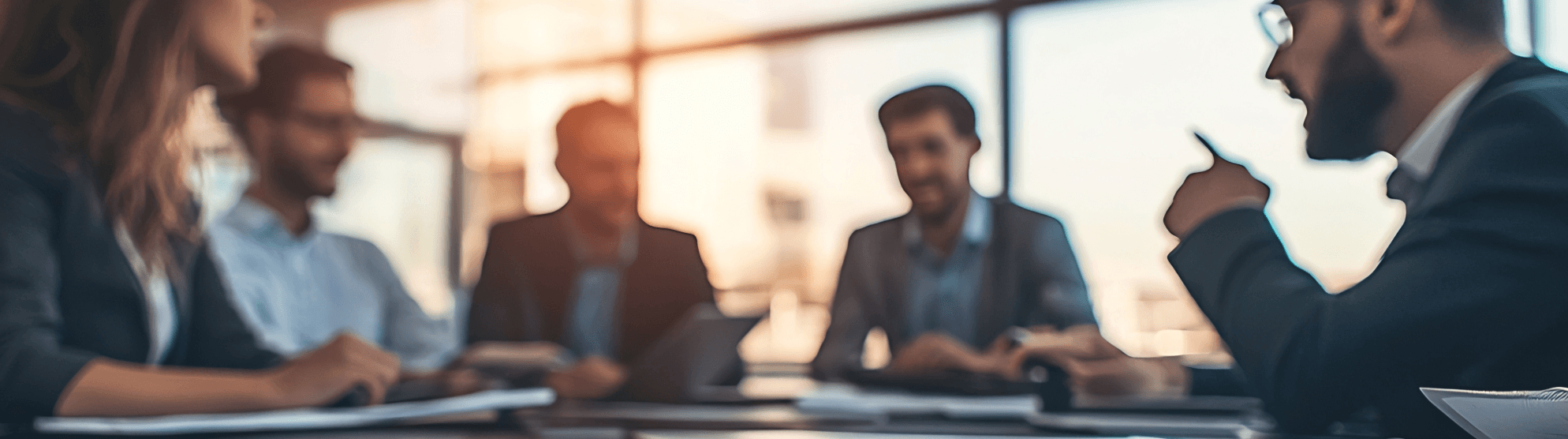 Business meeting of DACHSER & KOLB employees in a bright, modern office setting.