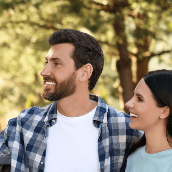 Two couples of different ages having a friendly conversation outdoors. Getting to know the neighborhood after moving.