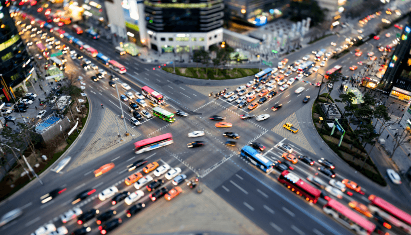 Bird's-eye view of a busy intersection with heavy traffic. Information on special parking permit for moving.