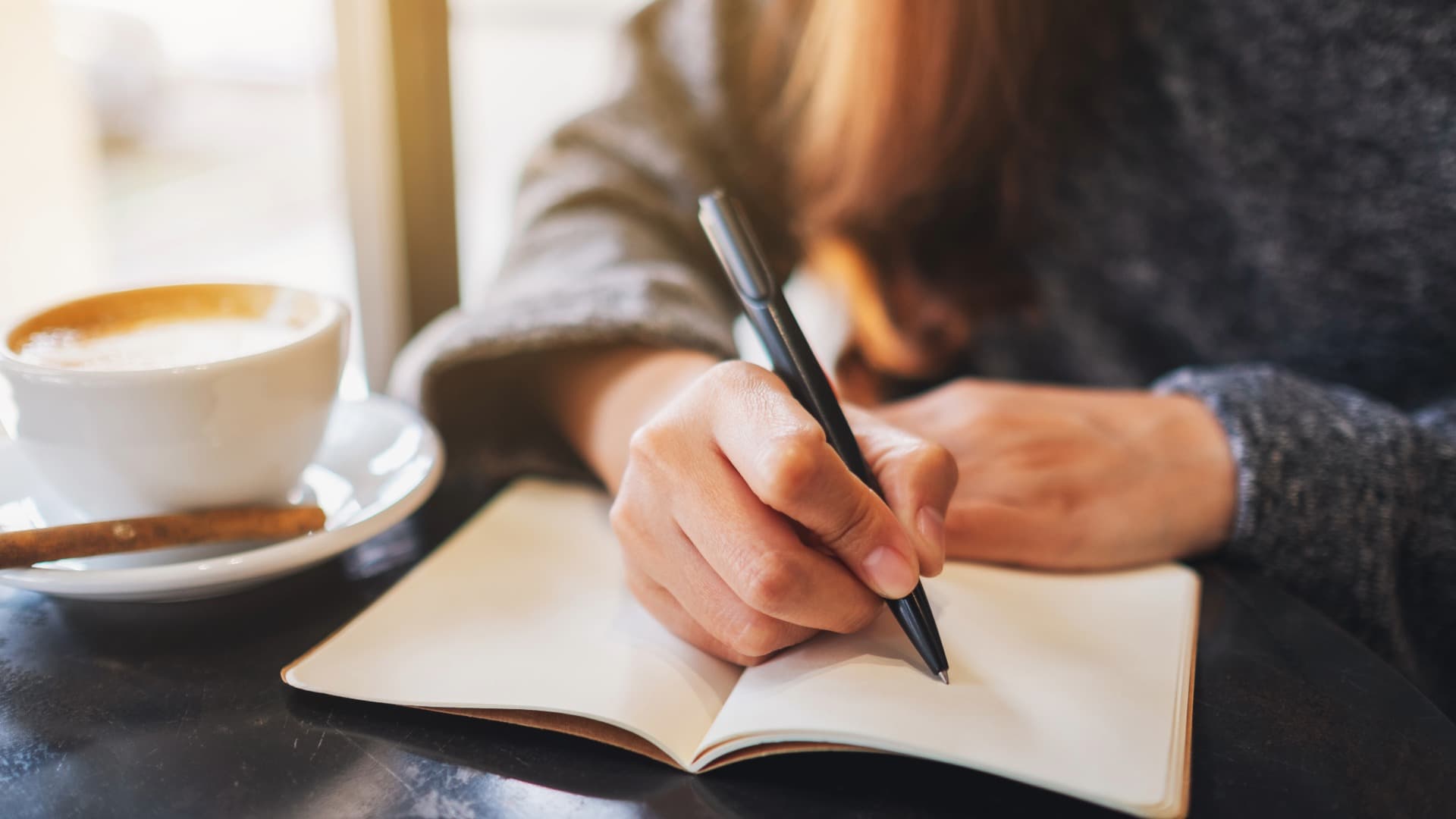 Person writing down moving details – planning for floors during a move