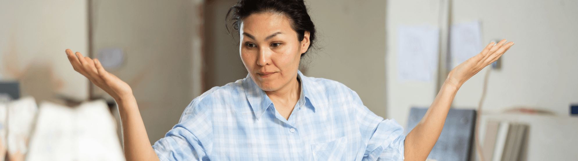 Stressed woman shrugs. Stress management during relocation, uncertainty, overwhelmed.