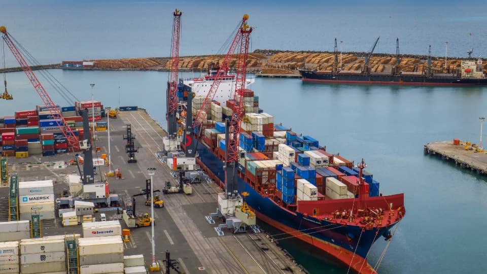 Large container ship at the Port of Napier terminal unloading ocean freight for inland transport in New Zealand with DACHSER & KOLB.