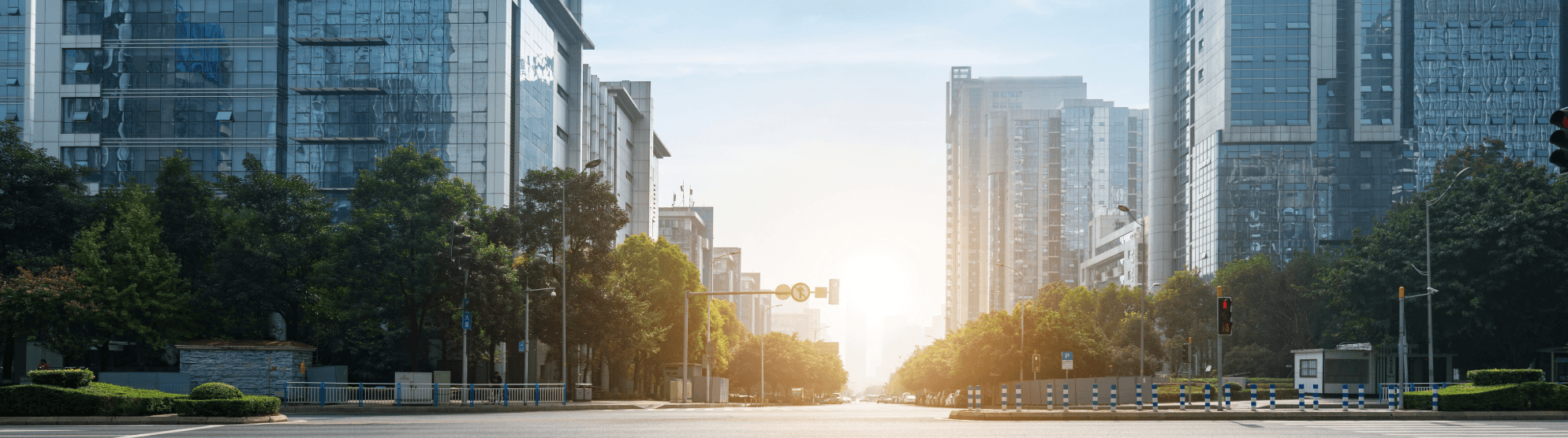 Sunrise in a modern cityscape with wide streets – symbolic of accessible and user-friendly moves in metropolitan areas