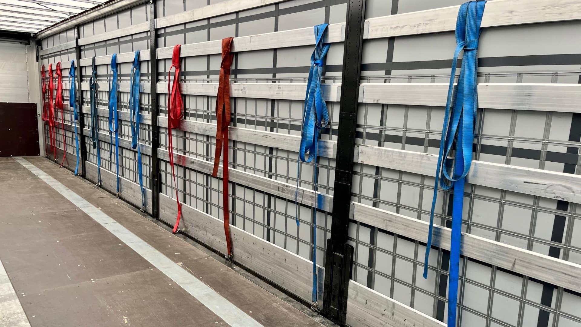 Organised moving straps in truck, ready for safe load securing during the next relocation.