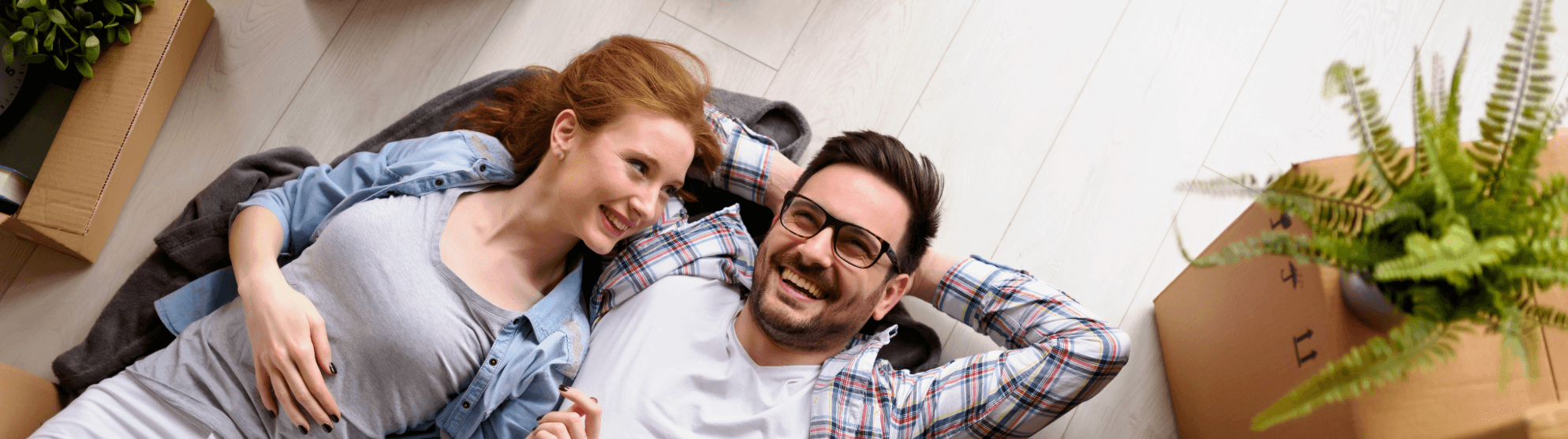 Young couple relaxing after moving – happy moment as part of moving planning and practical tips.