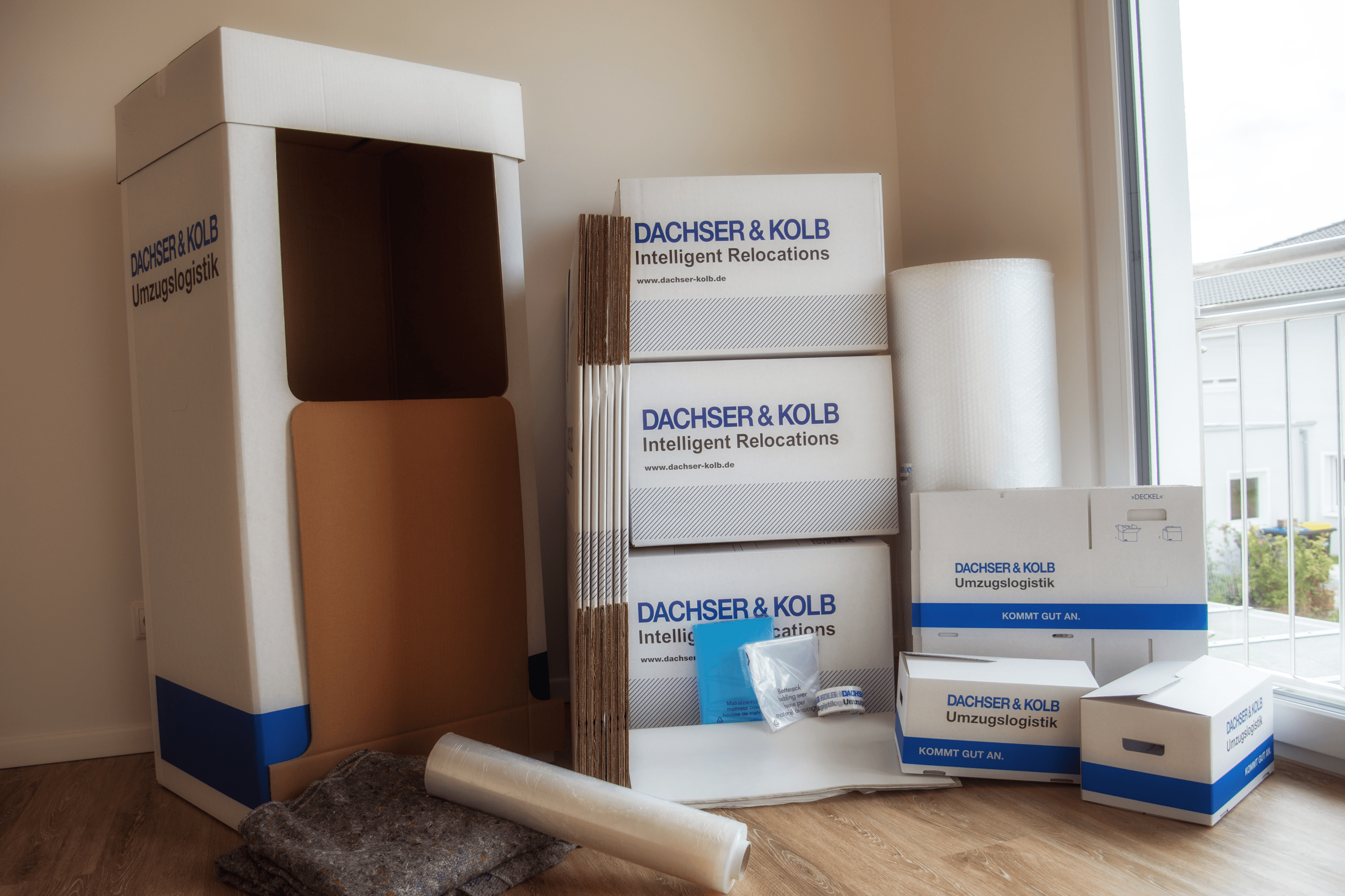 Boxes, bubble wrap and accessories arranged in a bright corner of an apartment.