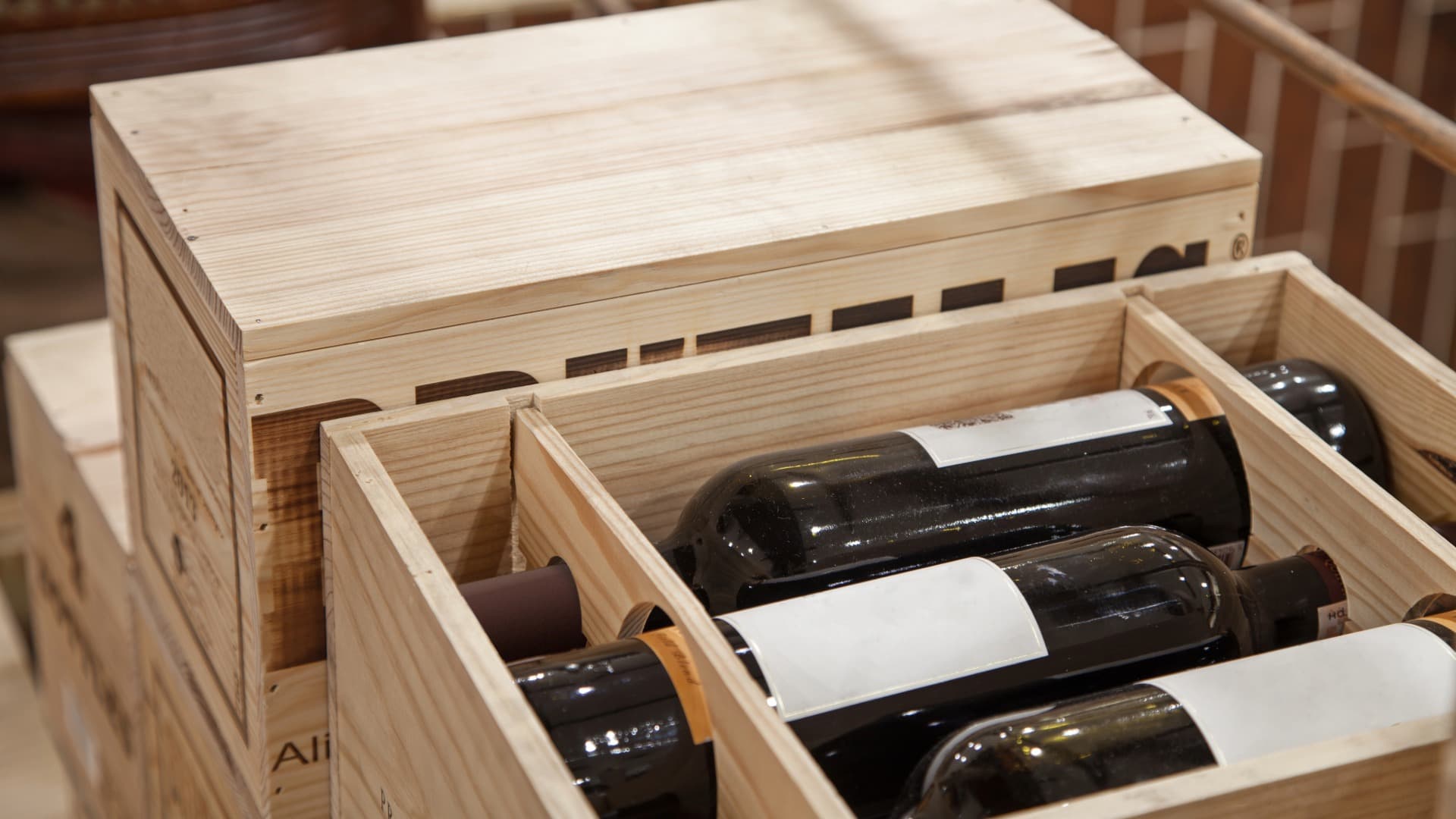 Wine bottles secured in a wooden wine carton – protective packaging for transport and storage