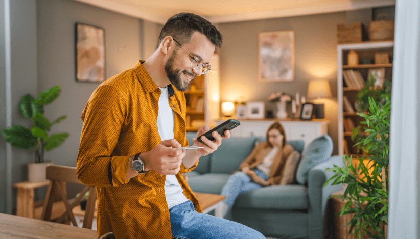 Man shows interest in apartment application via smartphone after viewing