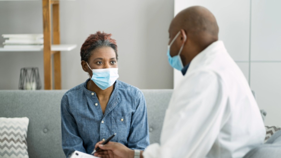 A Kenyan doctor is consulting with a patient at a clinic