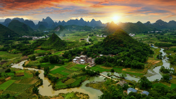 A landscape featuring forests, meadows, mountains, and a river in Taiwan