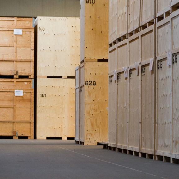 Row of numbered wooden crates in a secured moving storage facility for safe relocation storage.