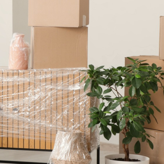 A living space with packed furniture and stacked moving boxes. Symbolizing relocation service for private individuals.