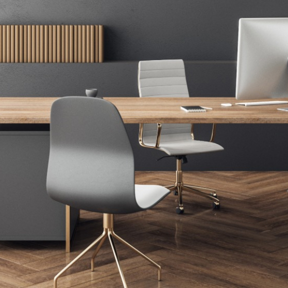A modern, minimalist executive office with a view of a city skyline, symbolizing professional move management for corporate projects by DACHSER & KOLB.