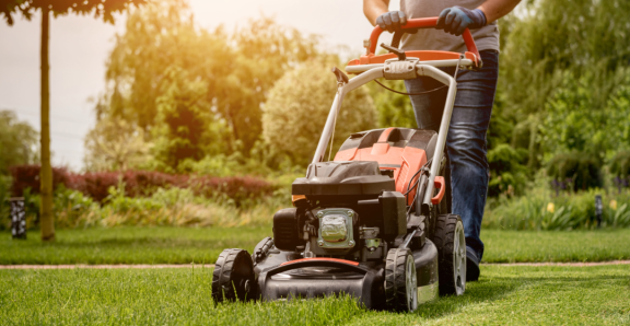 Person mowing the lawn while the Relocation Service for Expats assists with apartment search.