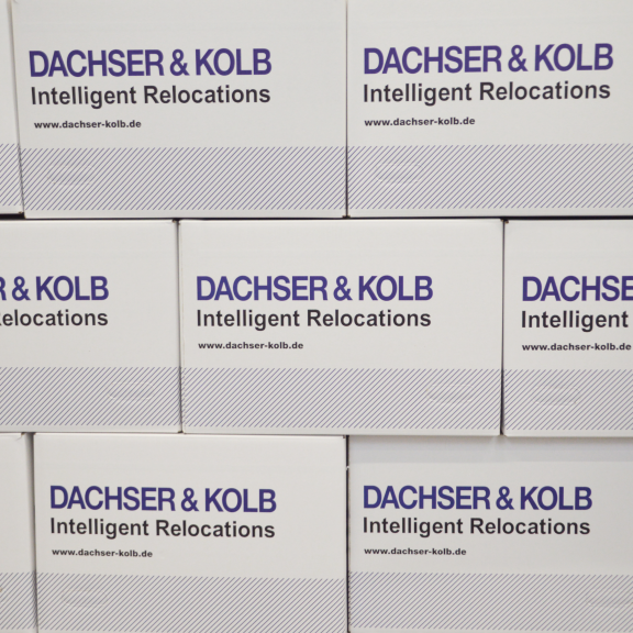 Moving boxes by DACHSER & KOLB with slogan