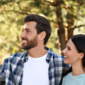 Two couples of different ages having a friendly conversation outdoors. Getting to know the neighborhood after moving.