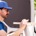 Movers loading furniture into van – ensure proper disposal and recycling during relocation
