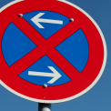 No stopping sign (arrows left/right). Information to apply for a no-parking zone