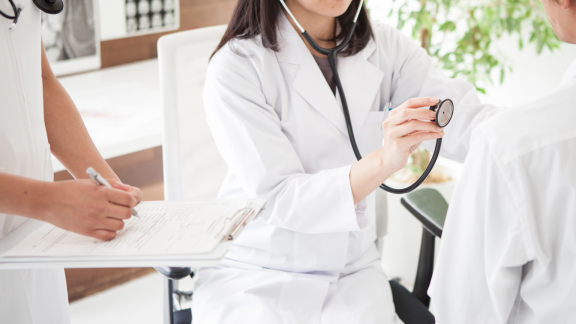 Doctor examining a patient in a clinic as a symbol of the healthcare system in Iceland
