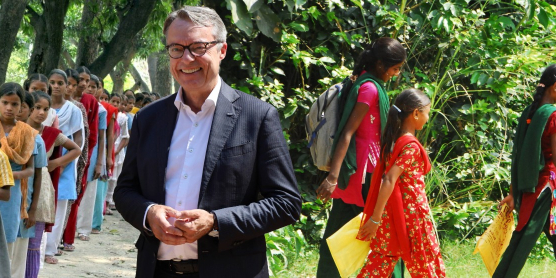 Children at a Terre des Hommes initiative for education and child rights, accompanied by a supporter.