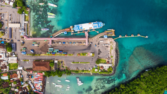 Containerschiff bei Sonnenuntergang im Hafen – Symbolbild für Planung zur Vermeidung von Havarien im Seetransport