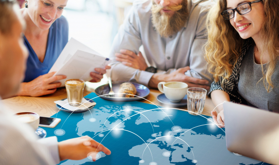 Team meeting on relocation service for expats with global map and network lines in a modern office over coffee.