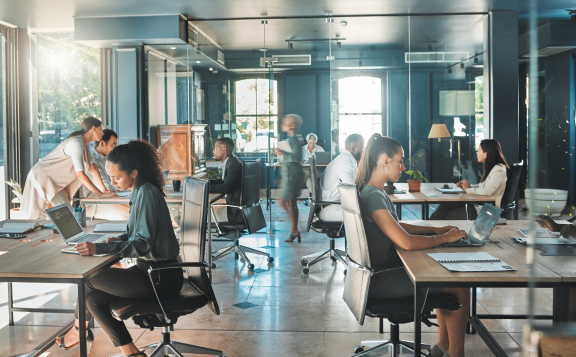 Professional co-working space with multicultural team working – relocation service for expats.